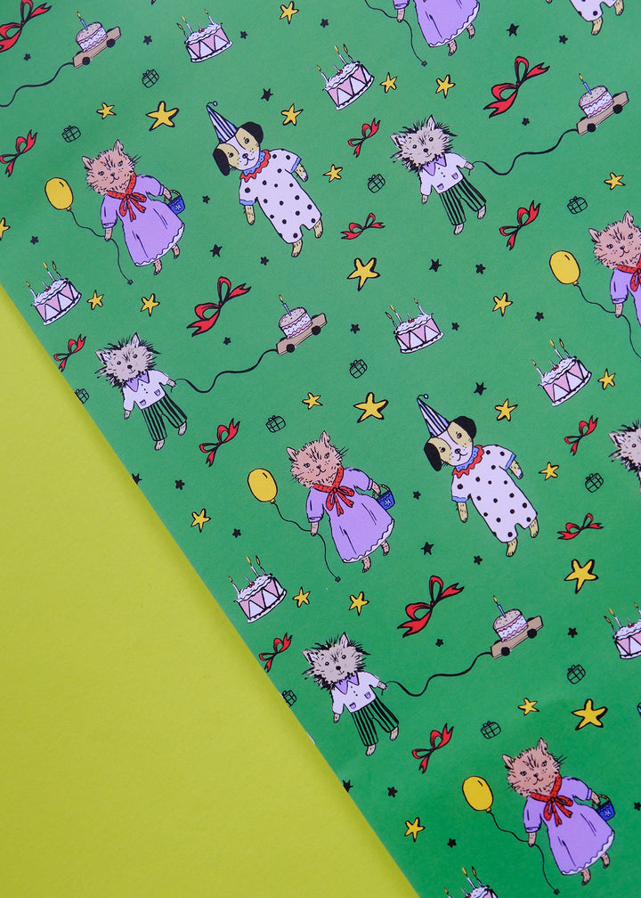 Patterned paper with cartoon characters on a green background